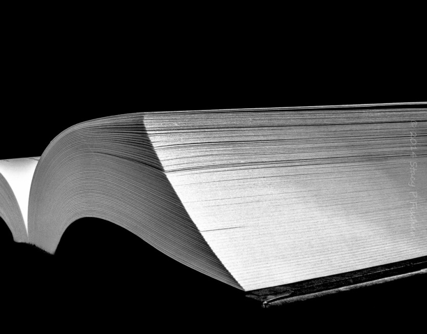 Looking at an open book from the right-hand side bottom corner. 