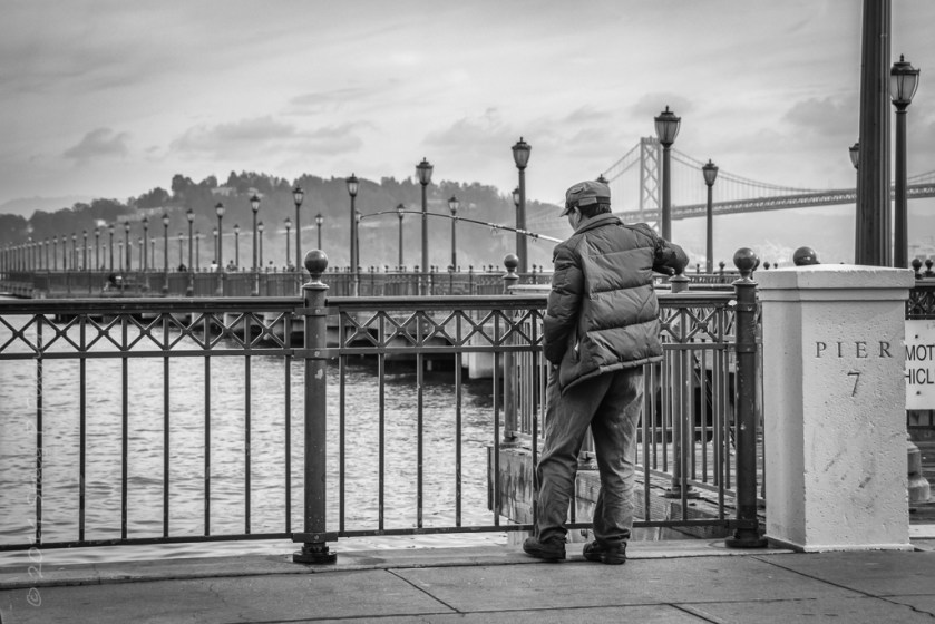 Fisherman at Pier 7, San Francisco, with Oakland Bay Bridge in the background