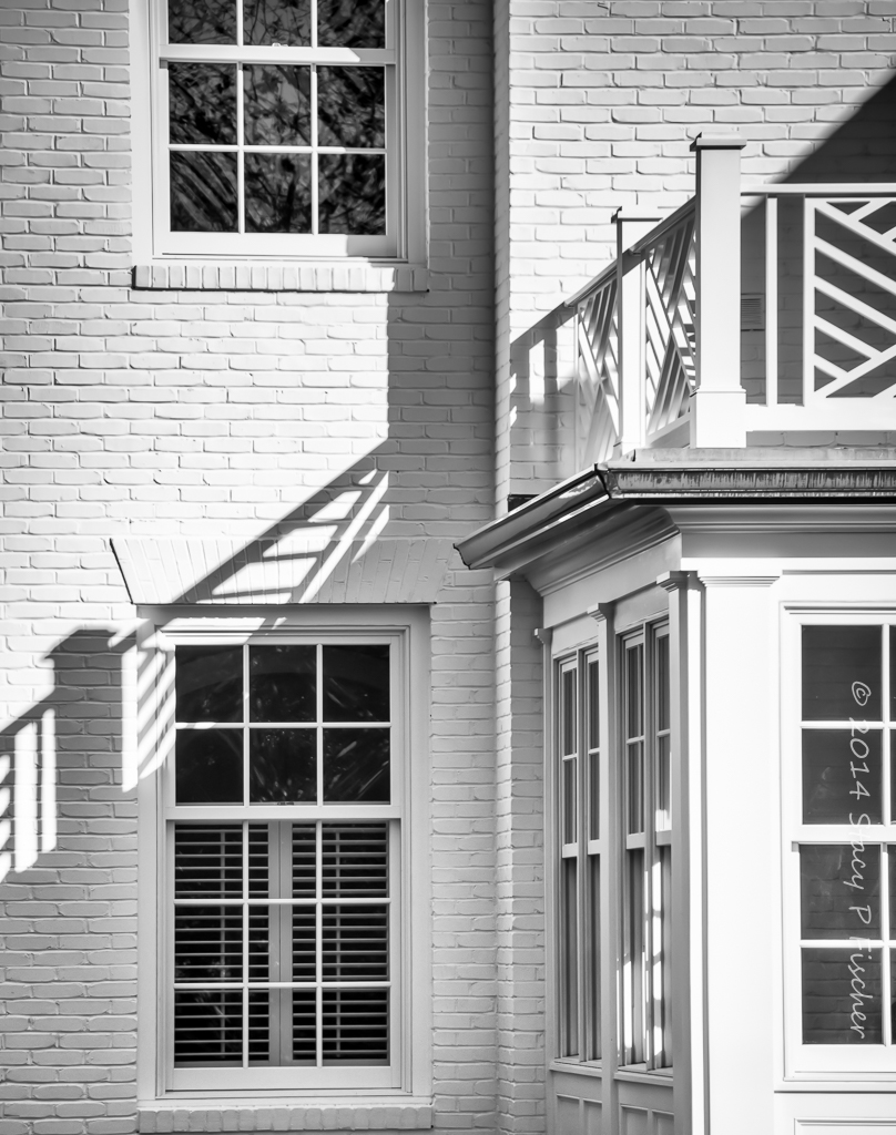 Windows and shadows on the exterior corner of a house