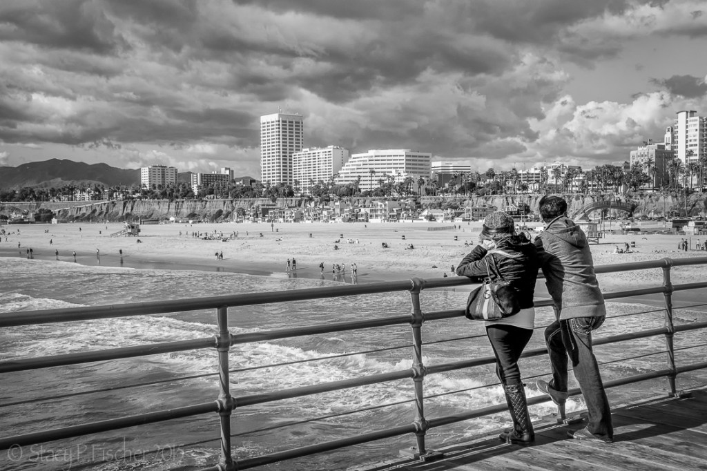 Couple views Santa Monica Beach from the pier.