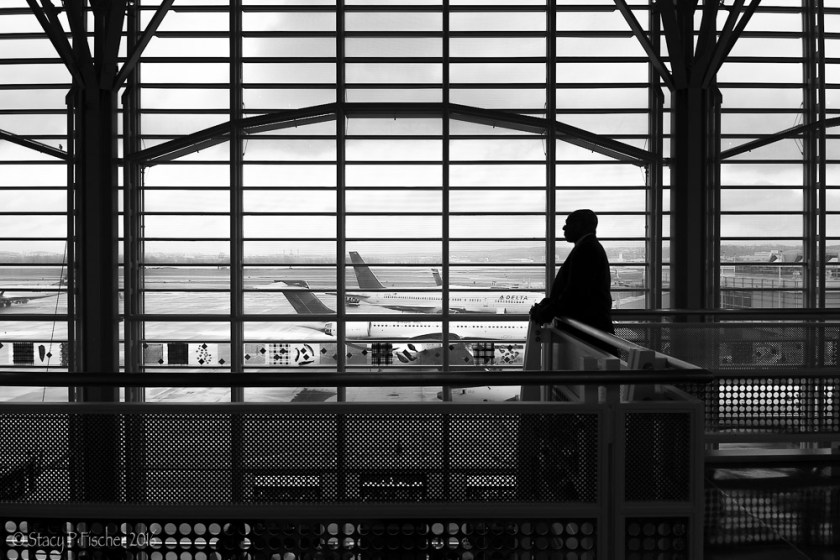 Man silhouetted against windows at Washington National Airport
