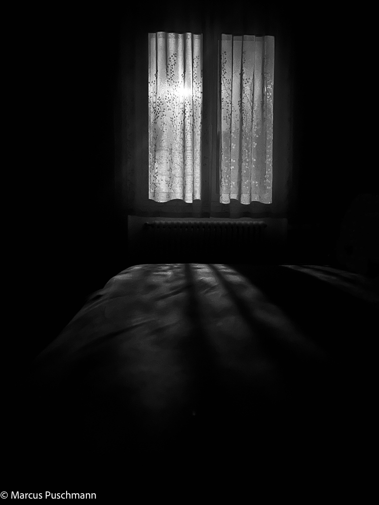 Full Moon shining through the curtains of a bedroom window